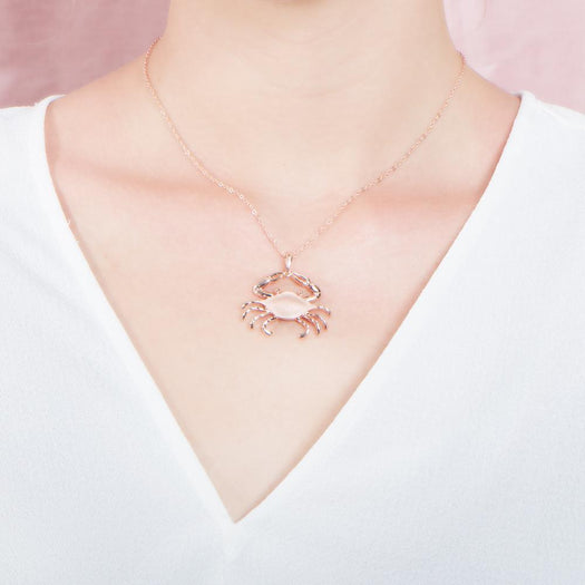 The picture shows a 925 sterling silver, rose gold vermeil crab pendant.