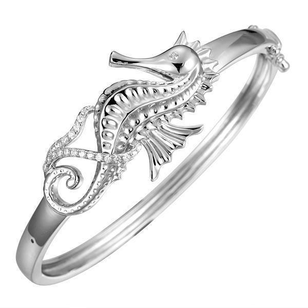 The picture shows a 925 sterling silver seahorse bangle with topaz.