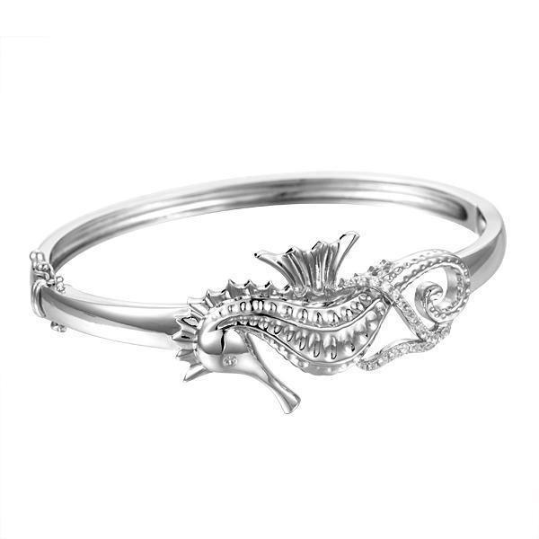 The picture shows a 925 sterling silver seahorse bangle with topaz.