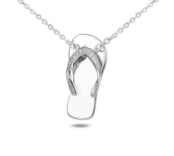 In this photo there is a sterling silver beach slipper pendant with topaz gemstones.