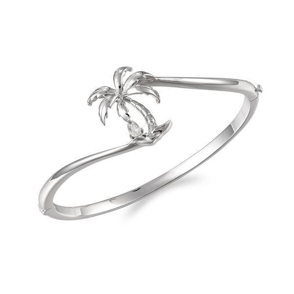 In this photo there is a 925 sterling silver beachside palm tree bangle with a topaz gemstone.