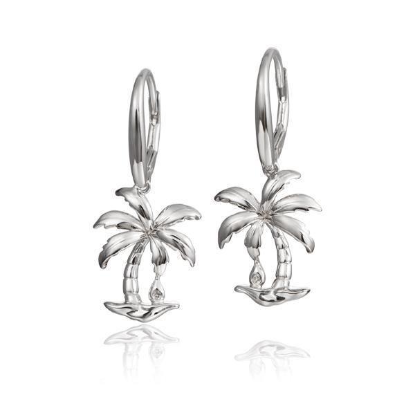 In this photo there is a pair of 925 sterling silver beachside palm tree lever-back earrings with topaz gemstones.