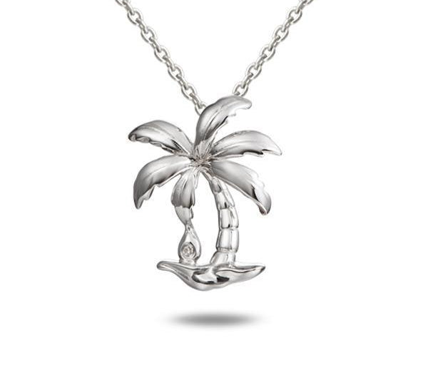 In this photo there is a sterling silver palm tree pendant with one topaz gemstone.