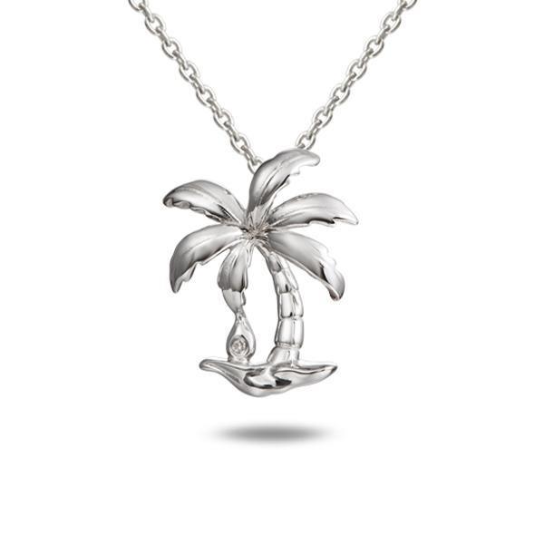 In this photo there is a sterling silver palm tree pendant with one topaz gemstone.