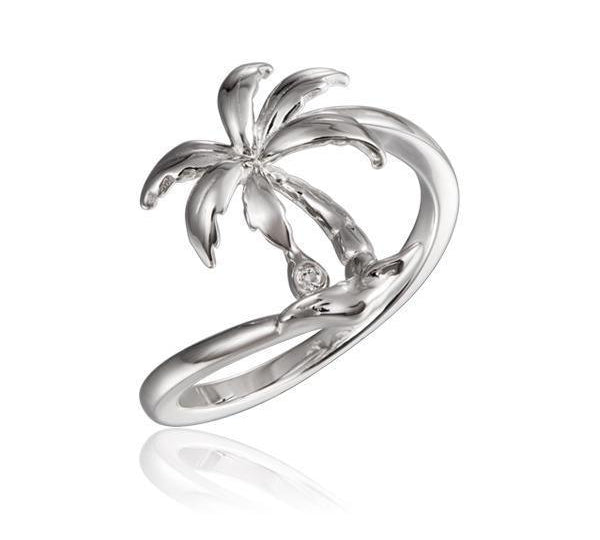 In this photo there is a 925 sterling silver beachside palm tree ring with a topaz gemstone.