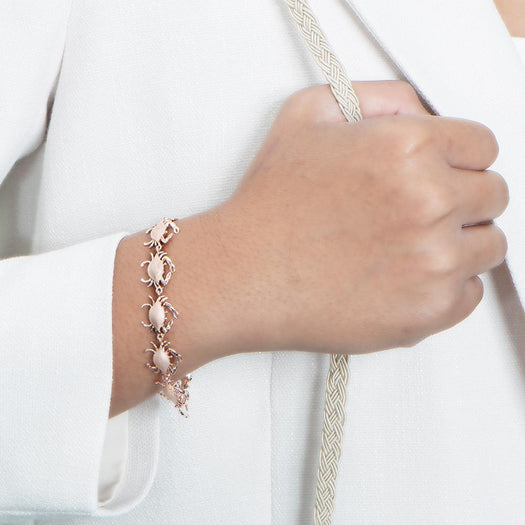 The picture shows a model wearing a 925 sterling silver white gold-plated blue crab bracelet.