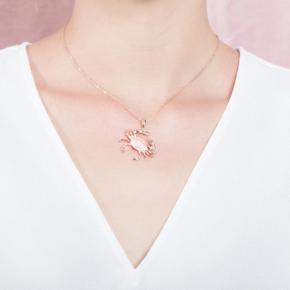 The picture shows a 925 sterling silver rose gold plated crab pendant.