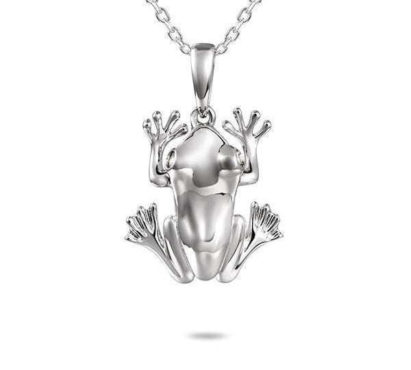 In this photo there is a sterling silver coqui frog pendant with topaz gemstones.