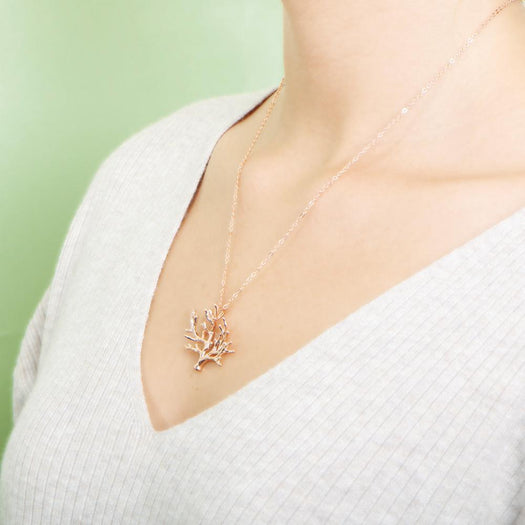 The picture shows a 925 sterling silver rose gold vermeil coral pendant.