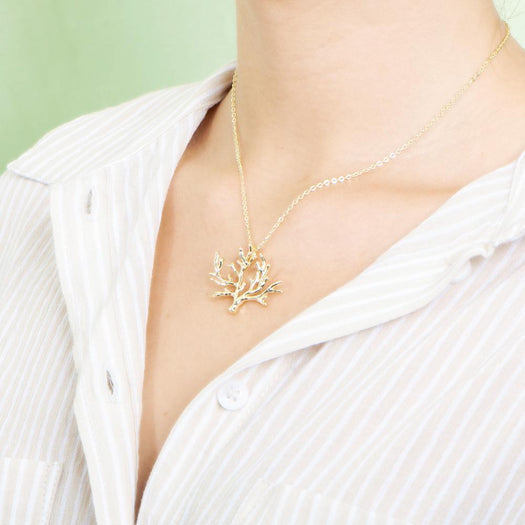 The picture shows a 925 sterling silver yellow gold vermeil coral pendant.
