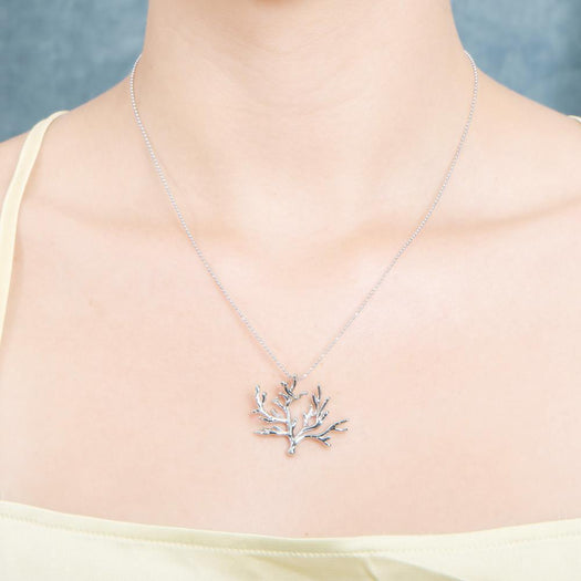 The picture shows a 925 sterling silver white gold vermeil coral pendant.