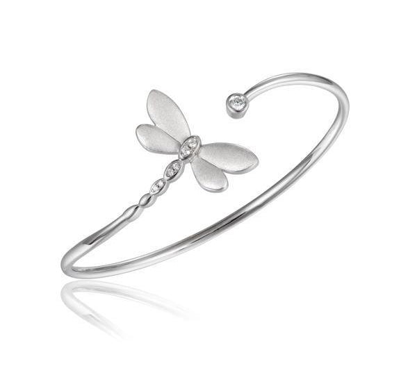 In this photo there is a sterling silver dragonfly bangle with topaz gemstones.