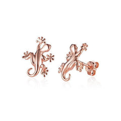 In this photo there is a pair of 14k rose gold gecko stud earrings.