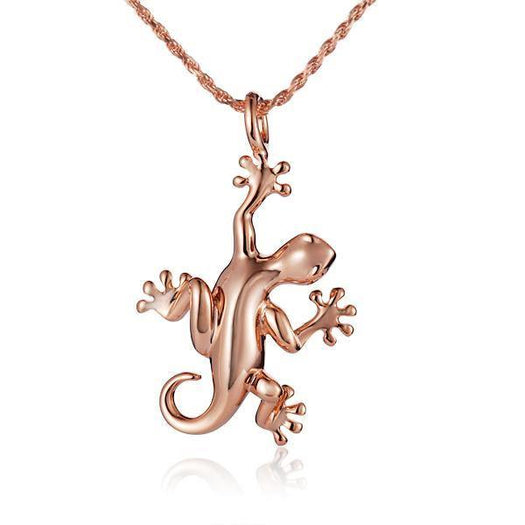 In this photo there is a rose gold gecko pendant.