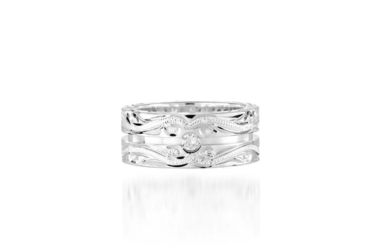 The picture shows a 925 sterling silver channel ring with hand engravings and diamonds.