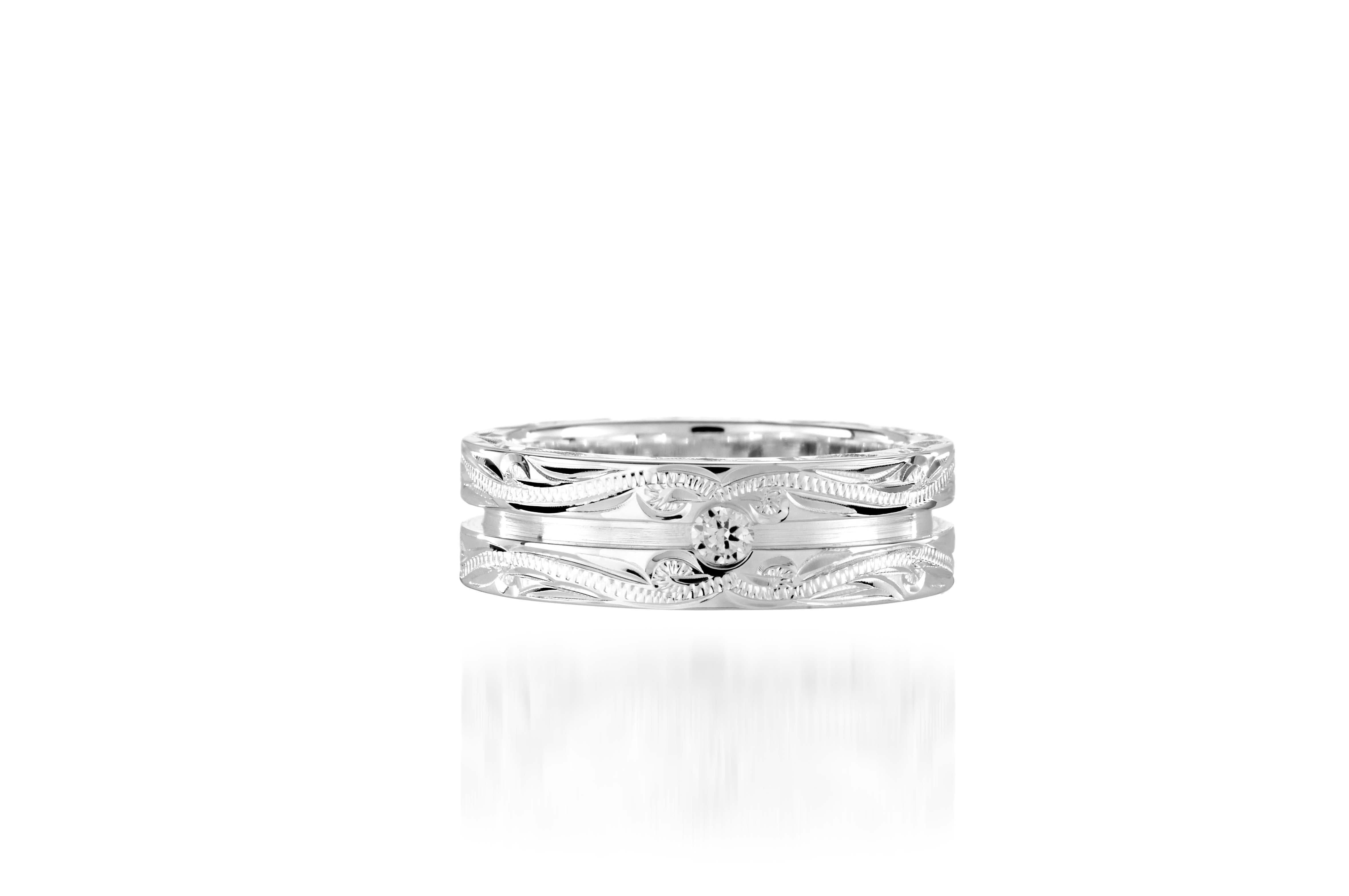 The picture shows a 925 sterling silver channel ring with hand engravings and diamonds.