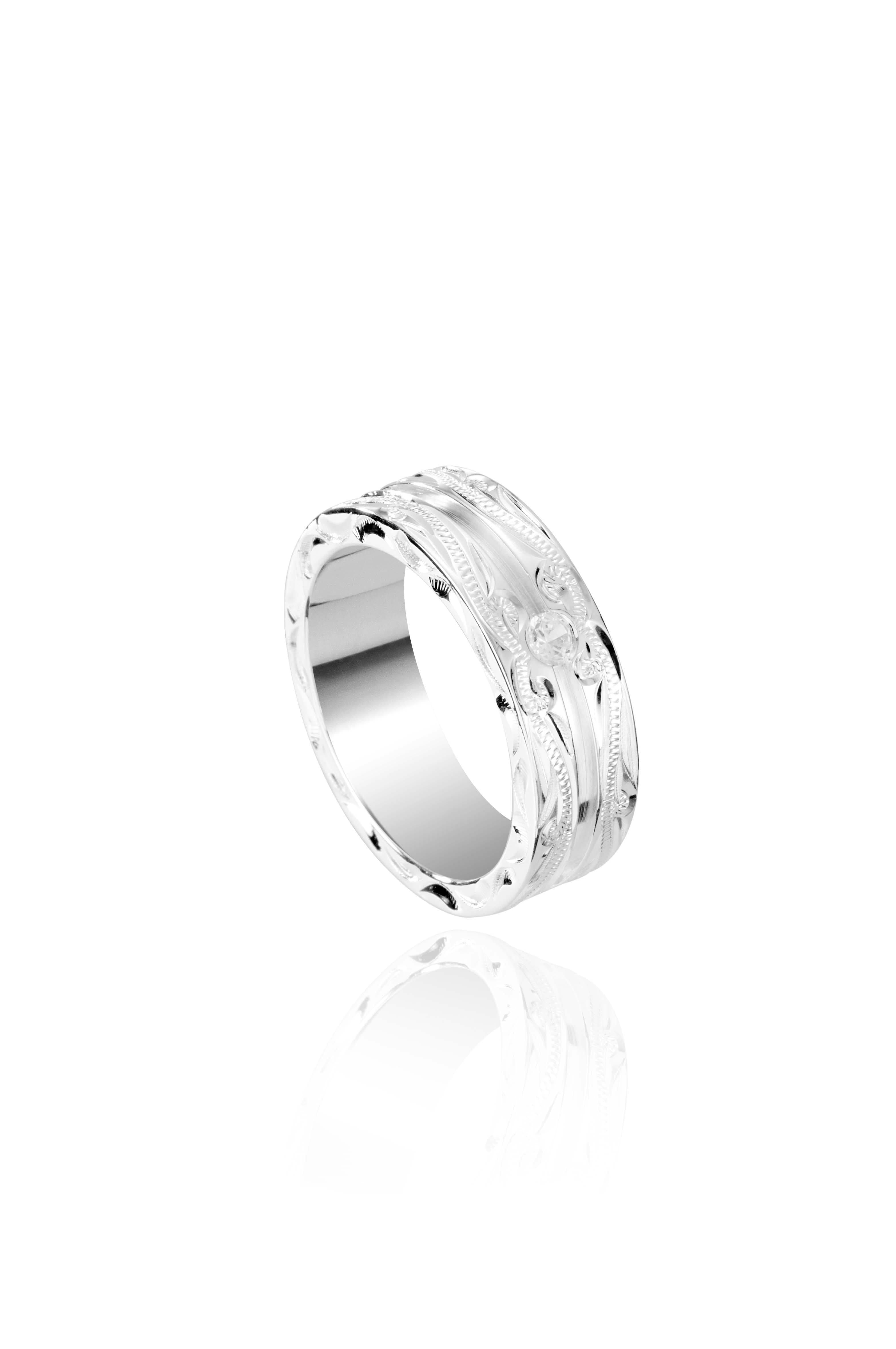 The picture shows a 925 sterling silver channel ring with hand engravings and diamonds.