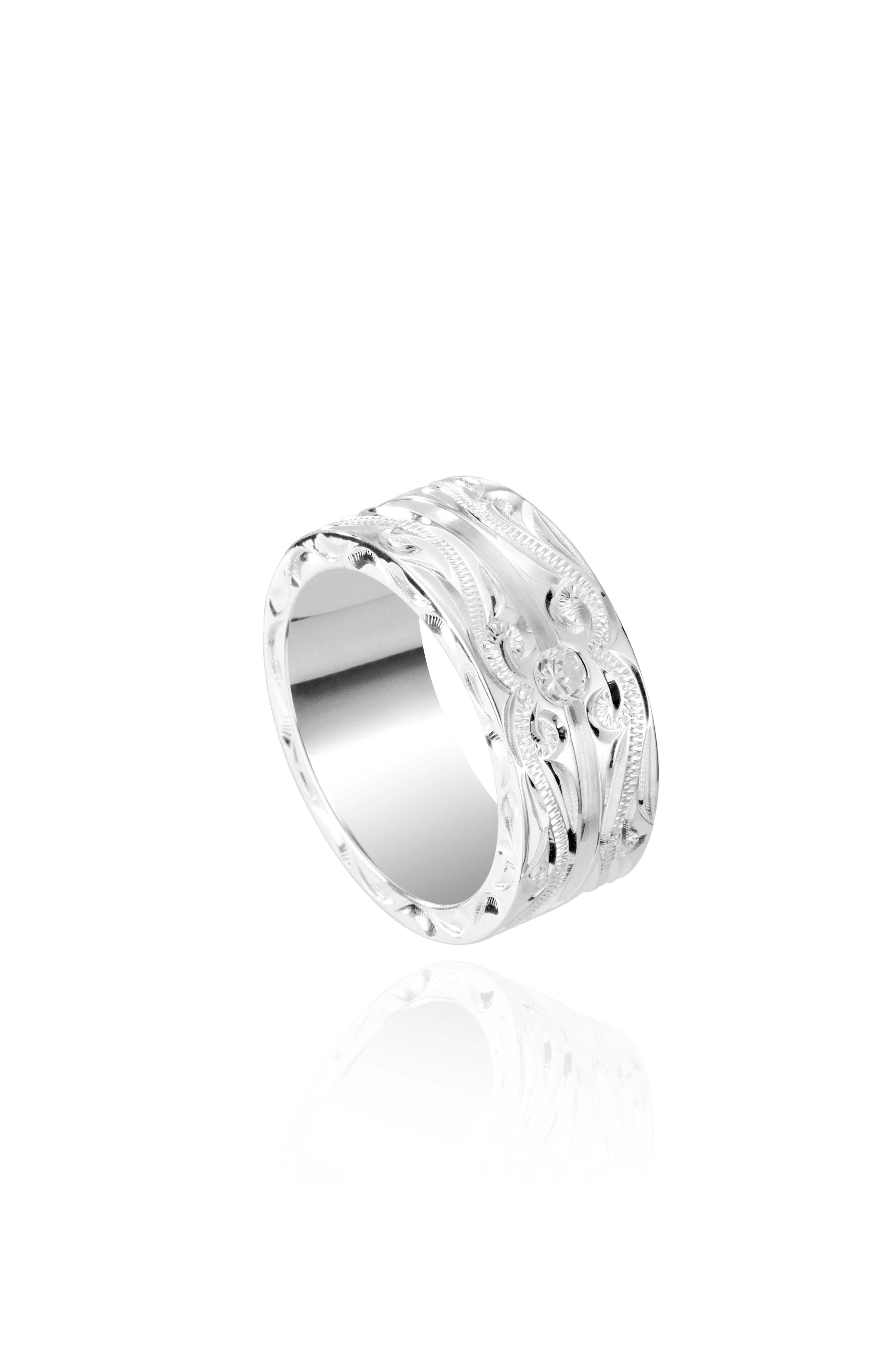 The picture shows a 925 sterling silver channel ring with hand engravings and diamonds.