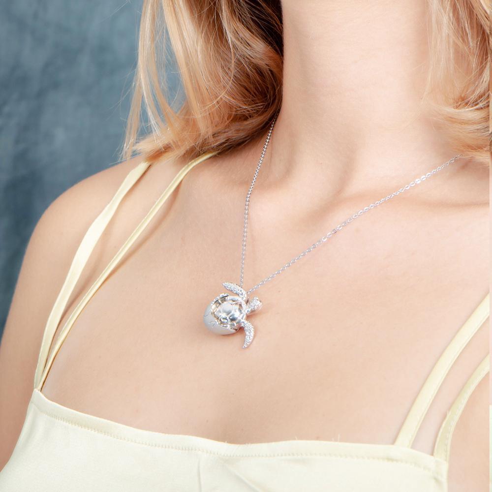 The picture shows a 925 sterling silver sea turtle hatchling pendant.