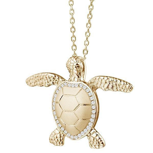 The picture shows a 14K yellow gold Hawaii Kai sea turtle pendant with diamonds.