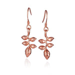 In this photo there is a pair of 14k rose gold heliconia flower hook earrings.