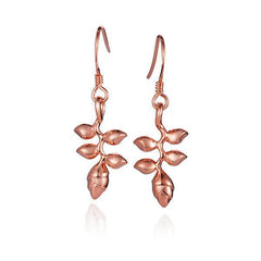 In this photo there is a pair of 14k rose gold heliconia flower hook earrings.