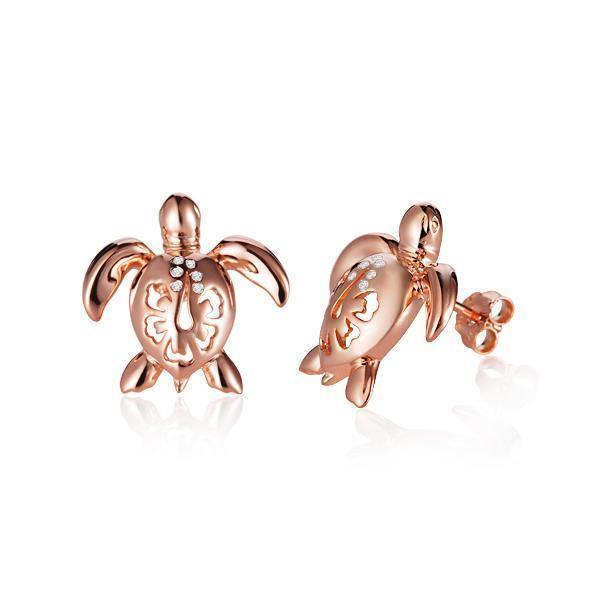 The picture shows a pair of 14K rose gold sea turtle stud earrings with a hibiscus flower cut-out design and diamonds.
