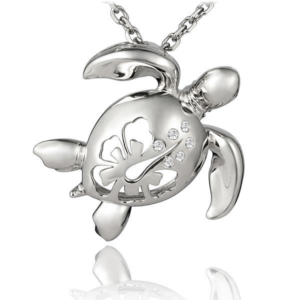 The picture shows a large 925 sterling silver sea turtle pendant with hibiscus cut-out and cubic zirconia.