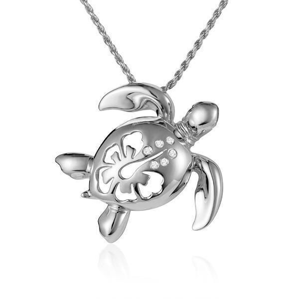 In this photo there is a white gold sea turtle pendant with a hibiscus flower cut-out and six diamonds.