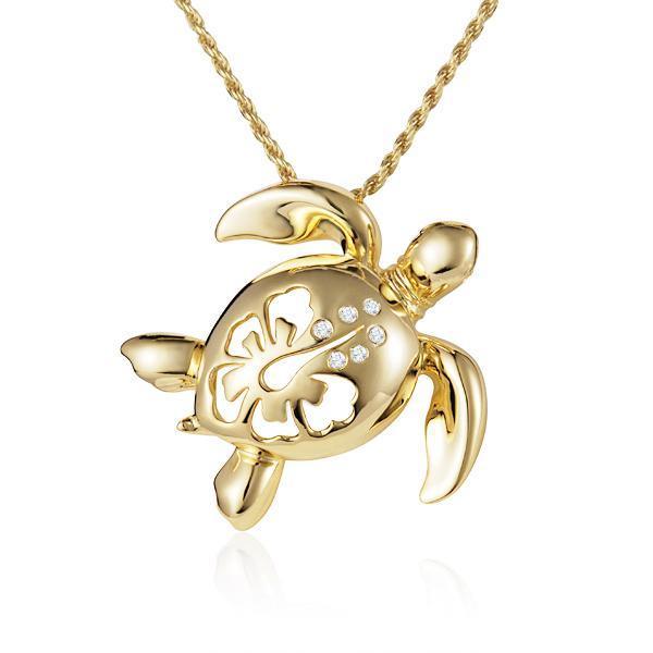 In this photo there is a yellow gold sea turtle pendant with a hibiscus flower cut-out and six diamonds.