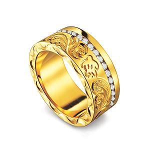 The picture shows a 14K yellow gold ring with hand engraved detailing and a sea turtle with a row of diamonds.