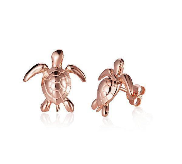 The picture shows a small pair of 14K rose gold sea turtle earrings.