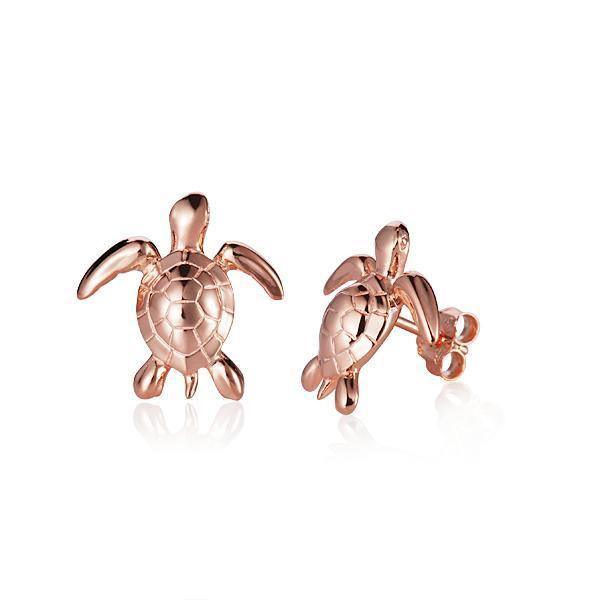 The picture shows a small pair of 14K rose gold sea turtle earrings.