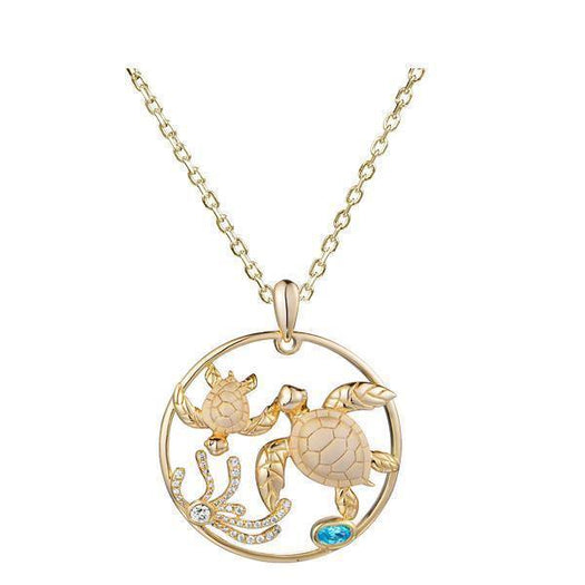 This picture shows a 14K yellow gold circle pendant featuring two sea turtles, sea weed of diamonds, and  aquamarine.