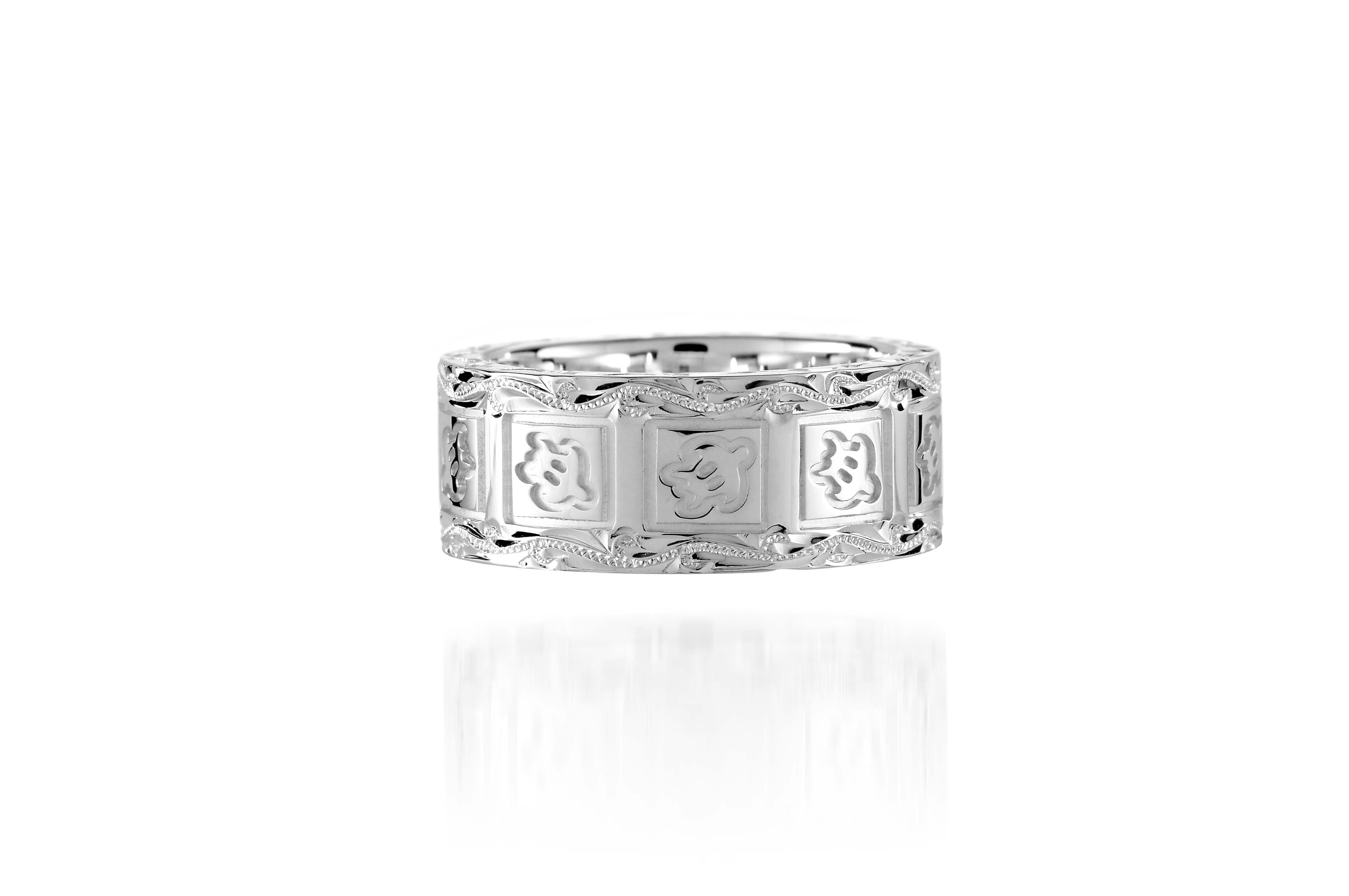 The picture shows a 925 sterling silver 8mm ring with hand engravings including sea turtles