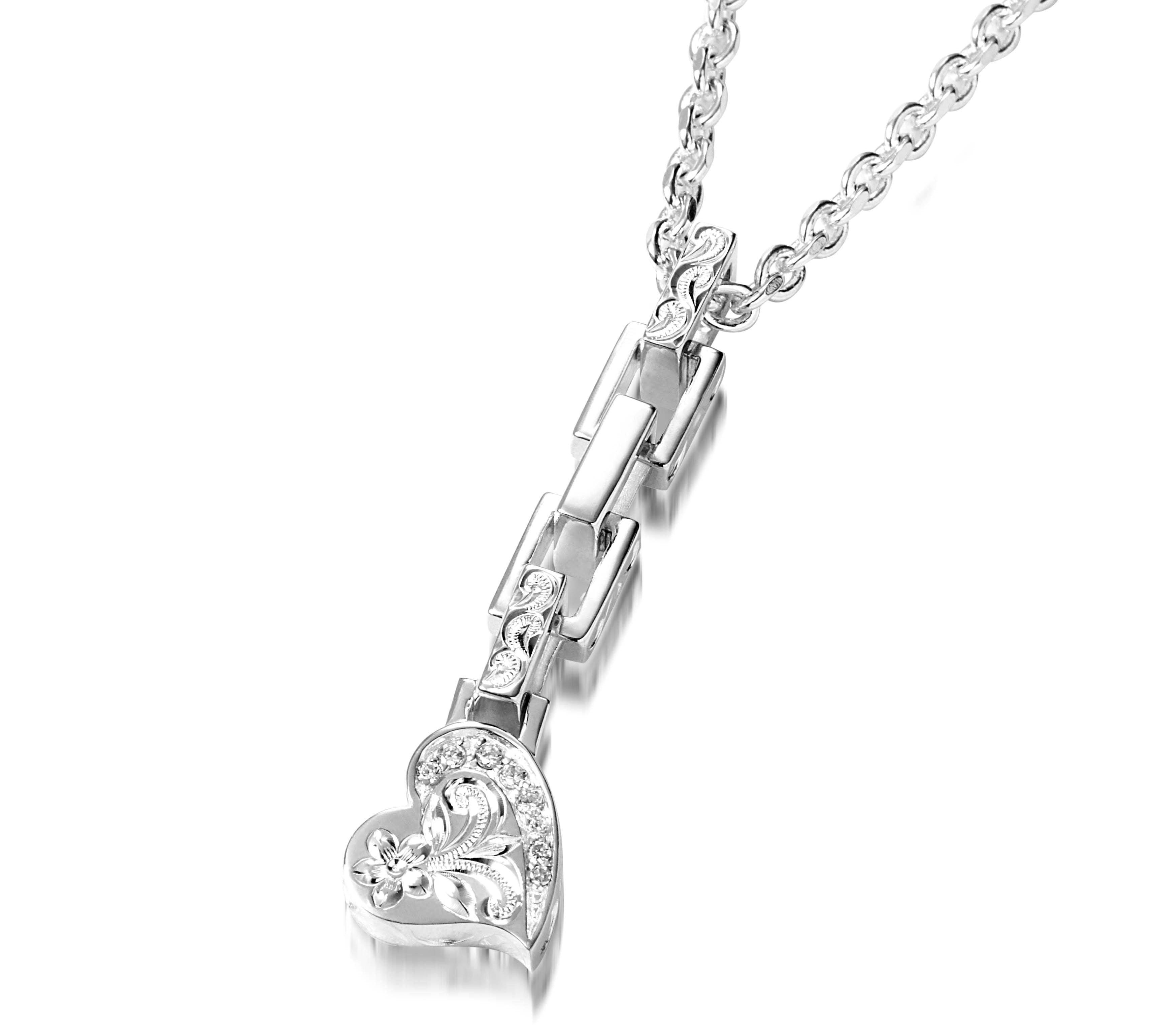 The picture shows a 925 sterling silver heart pendant with hand-engraved designs including a plumeria paired with diamonds.