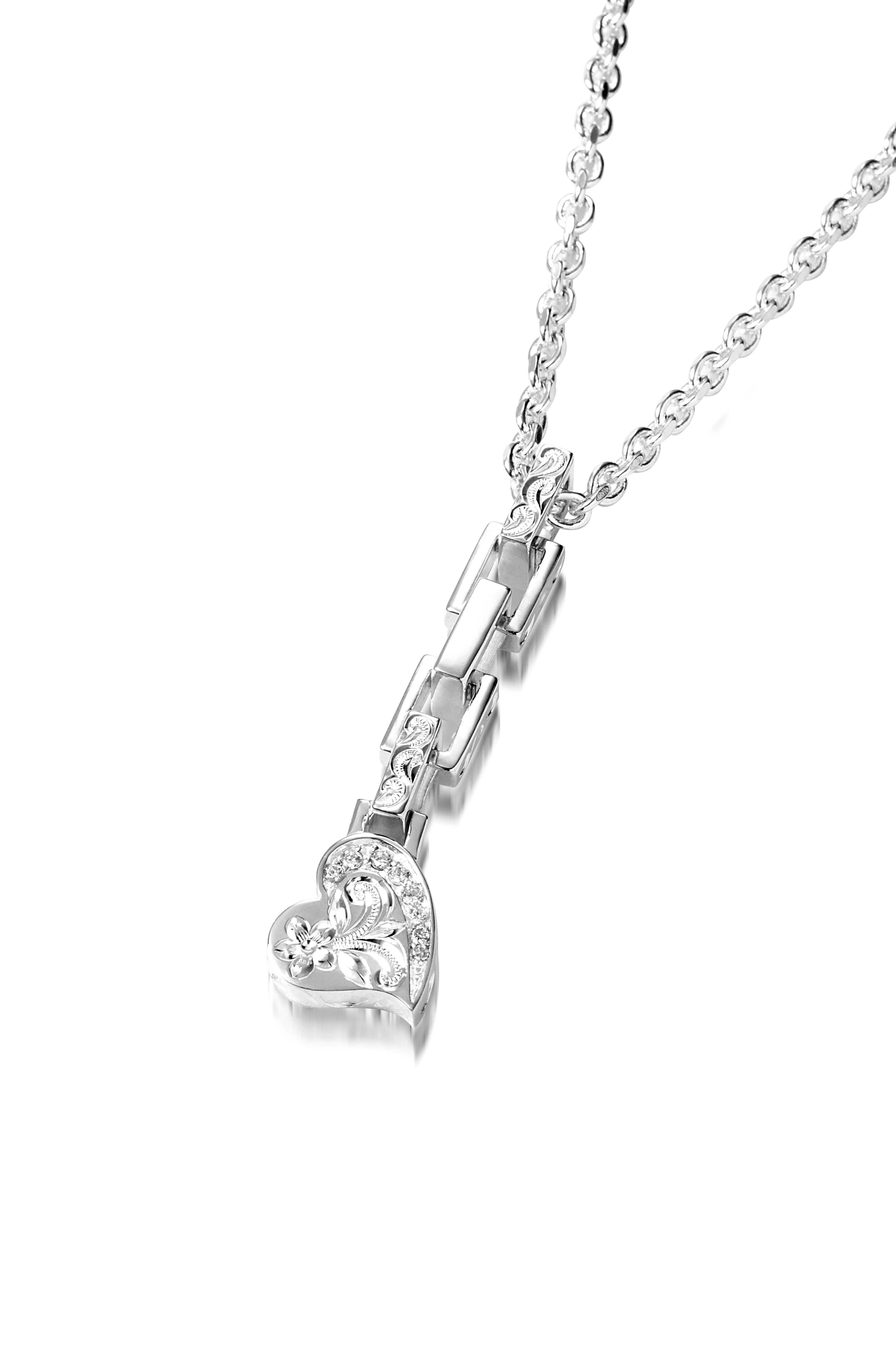 The picture shows a 925 sterling silver heart pendant with hand-engraved designs including a plumeria paired with diamonds.