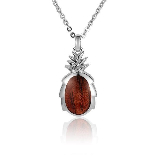 In this photo there is a small sterling silver and koa wood pineapple pendant.