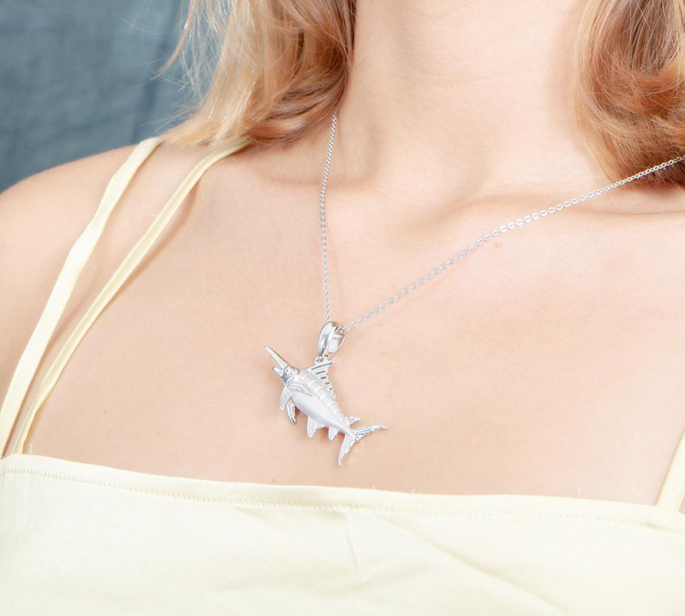 The picture shows a model wearing a 925 sterling silver marlin pendant.