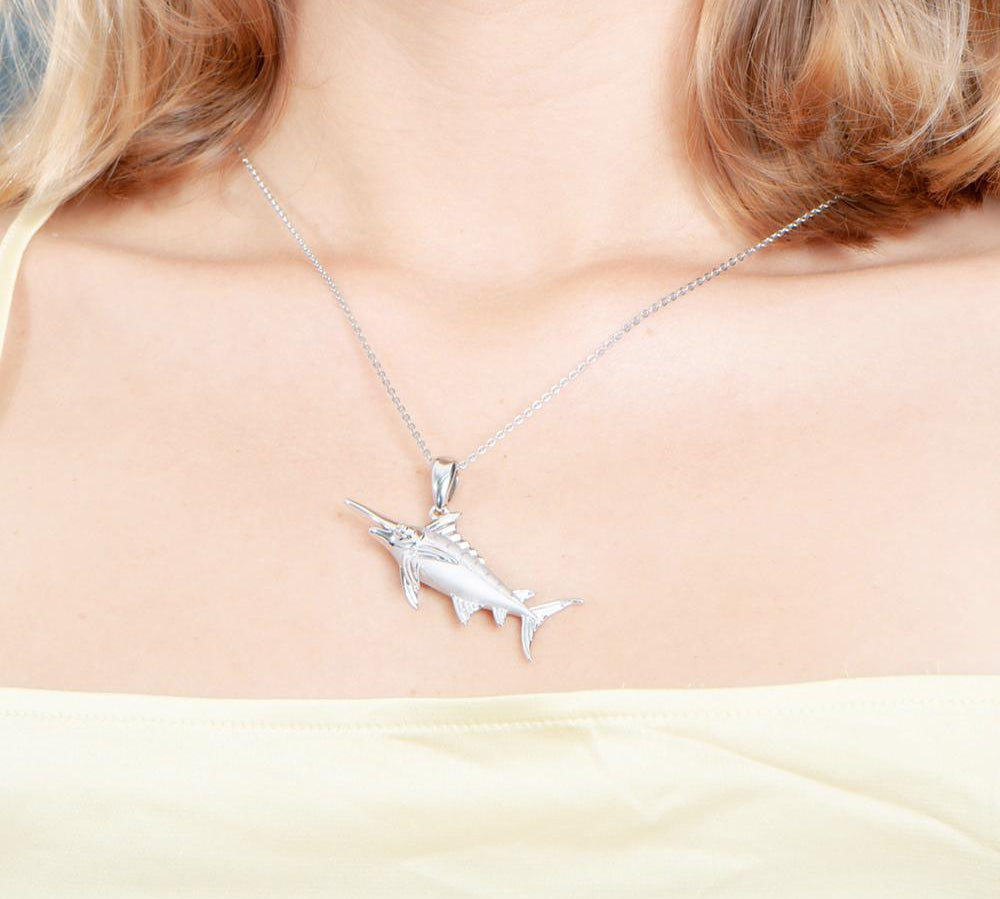 The picture shows a model wearing a 925 sterling silver marlin pendant.