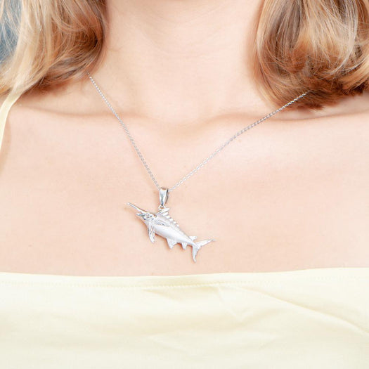 The picture shows a model wearing a 925 sterling silver marlin pendant.