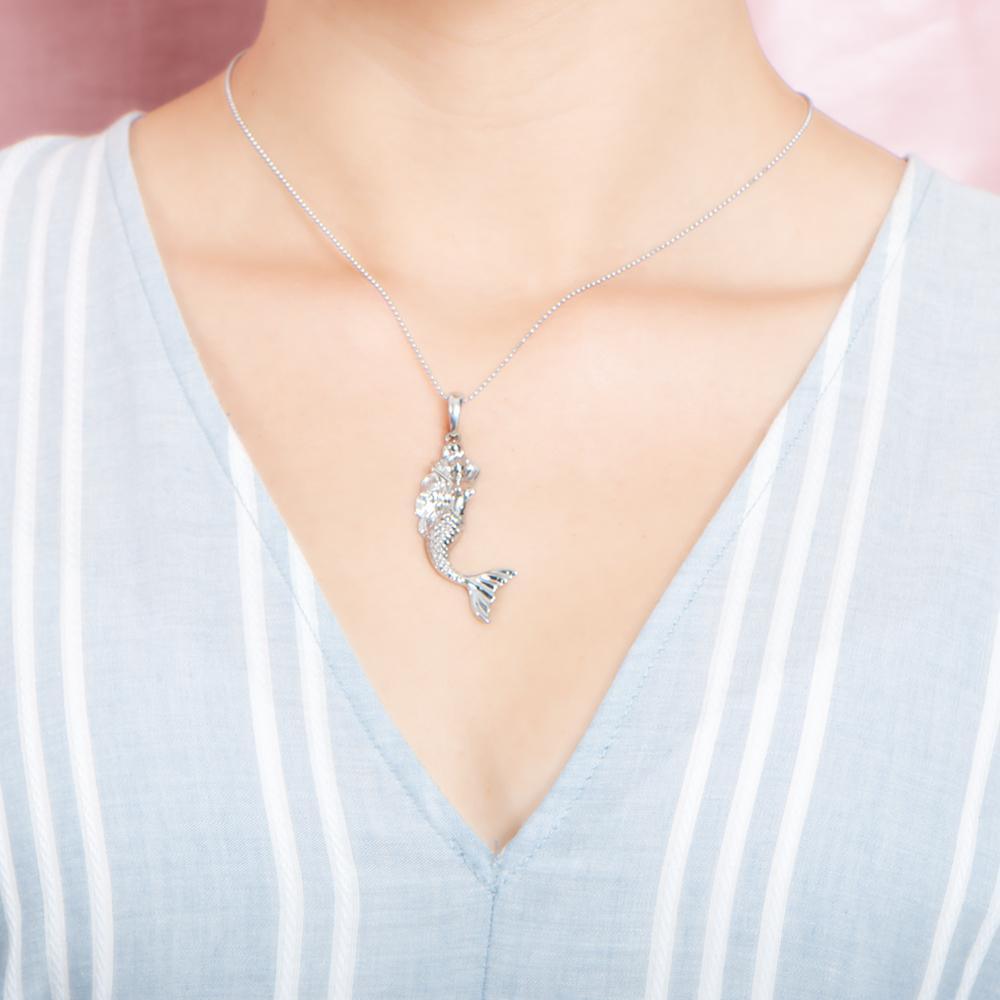 The picture shows a model wearing a large 925 sterling silver mermaid pendant.