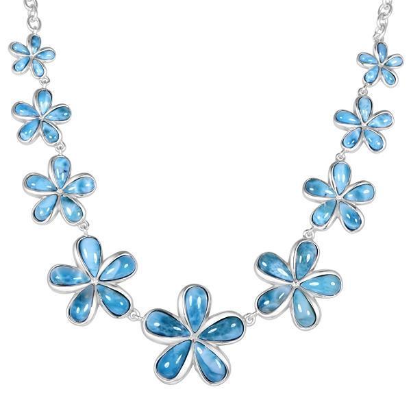 In this photo there is a sterling silver plumeria necklace with nine plumeria flowers and blue larimar gemstones.