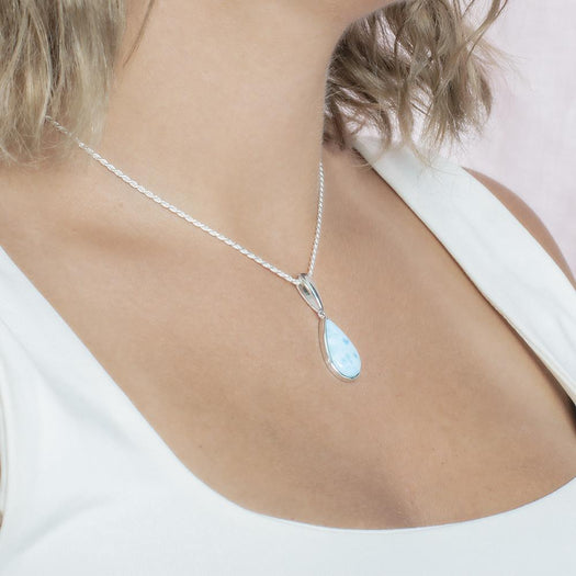 The picture shows a model wearing a 925 sterling silver larimar teardrop pendant.