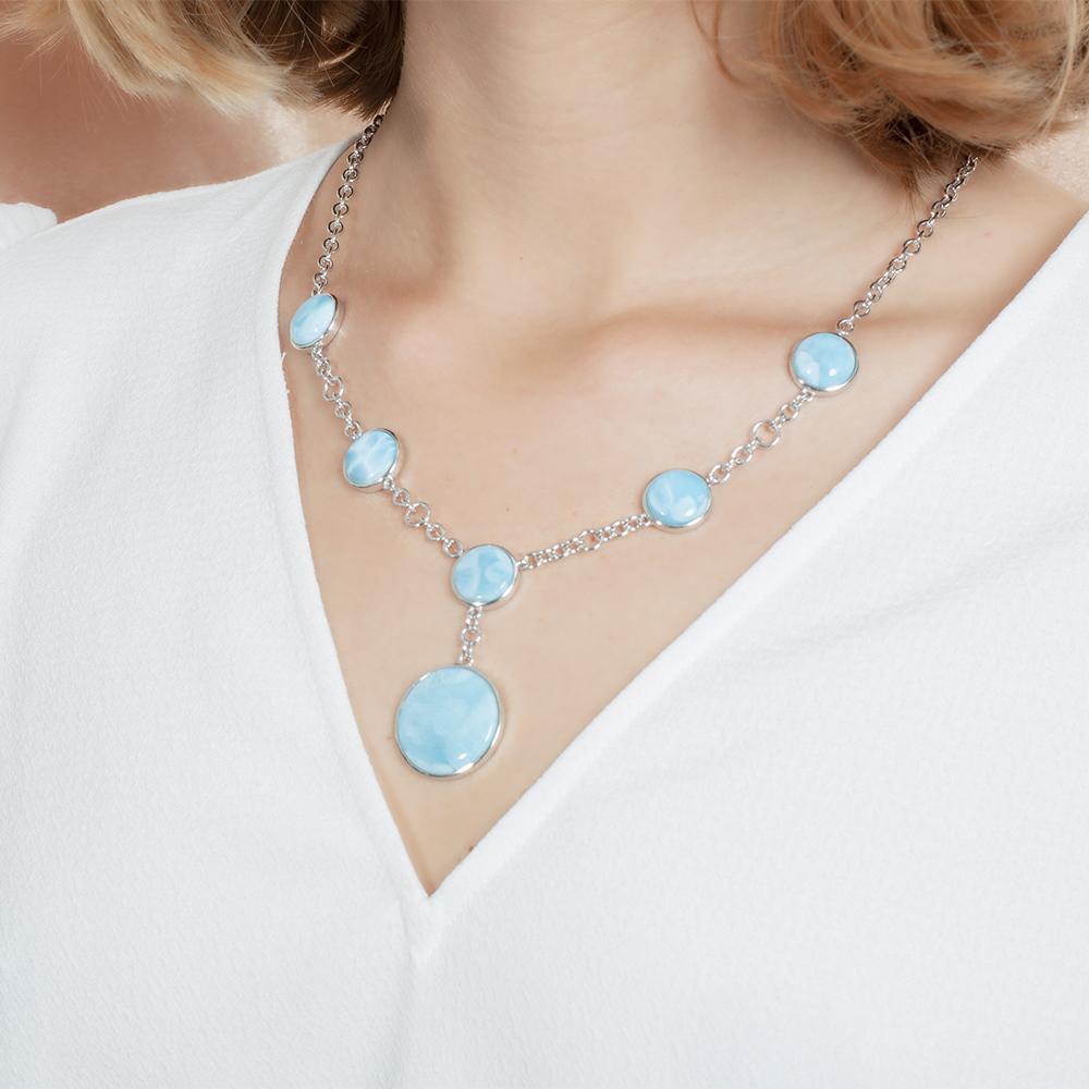 The picture shows a model wearing a 925 sterling silver larimar circle charm necklace.