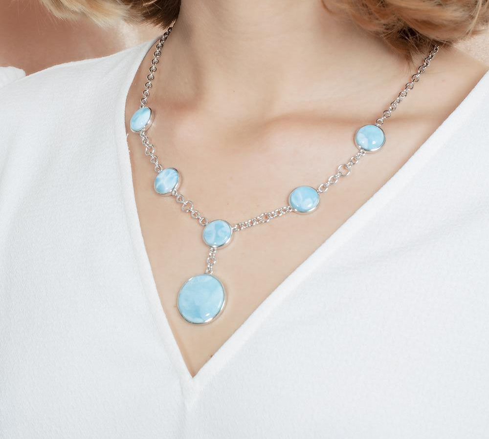 The picture shows a model wearing a 925 sterling silver larimar circle charm necklace.