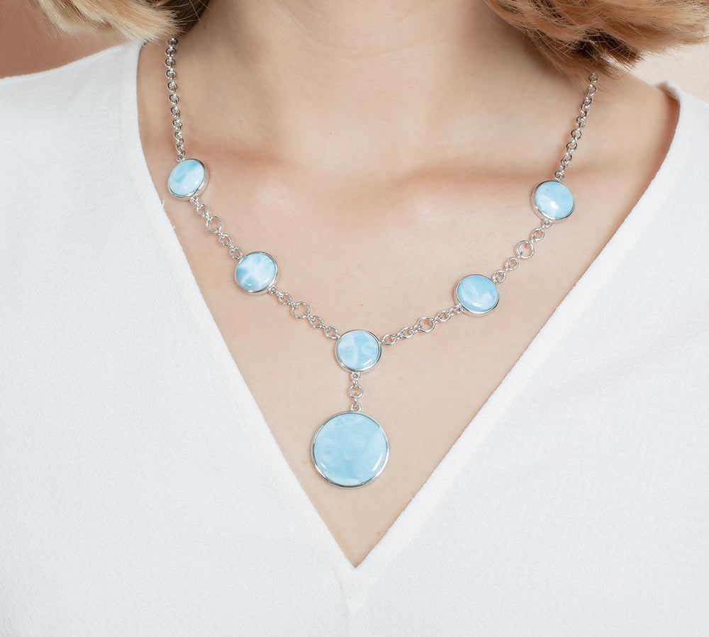 The picture shows a model wearing a 925 sterling silver larimar circle charm necklace.