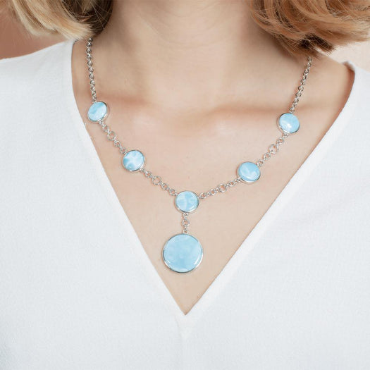 The picture shows a model wearing a 925 sterling silver larimar circle charm necklace.