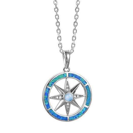 In this photo there is a sterling silver compass pendant with blue larimar, blue opalite, and topaz gemstones.
