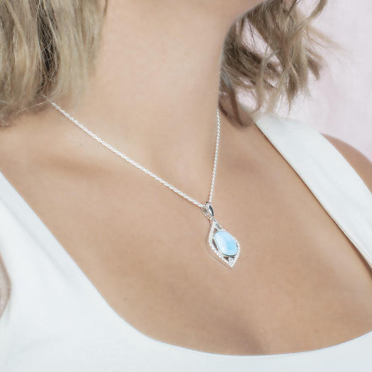 The picture shows a model wearing a 925 sterling silver larimar mandorla pendant.